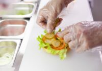 food truck worker using gloves while preparing food